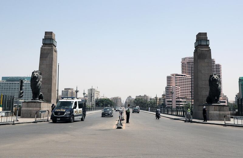 Egyptian policemen patrol the Qasr Nile bridge to ensure people abiding by restrictions during the national holiday of Sham El-Nessim. EPA