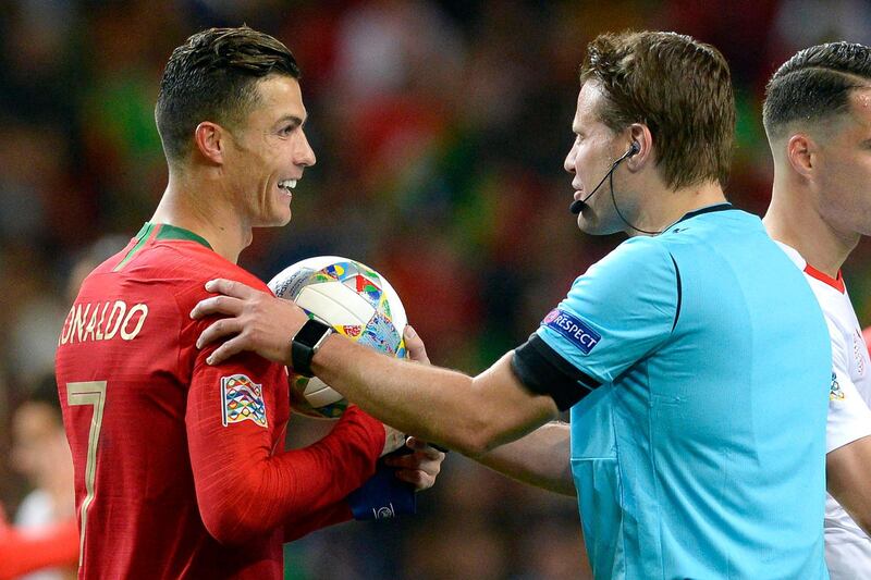 Ronaldo receives the match ball from German referee Felix Brych. EPA