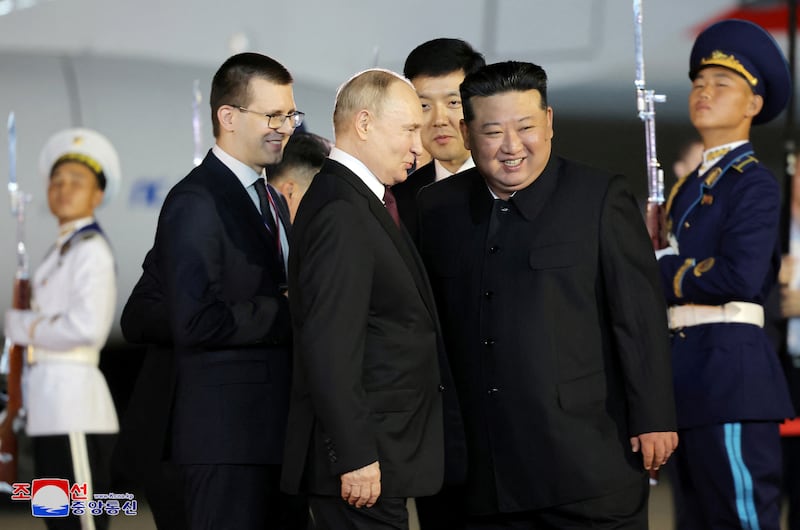 Mr Putin and Mr Kim share a laugh. Korean Central News Agency / Reuters