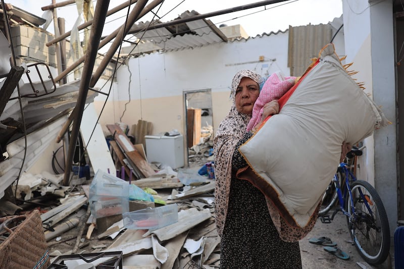 A Palestinian woman's home which was damaged during Israeli airstrikes on Rafah in the southern Gaza Strip. AFP