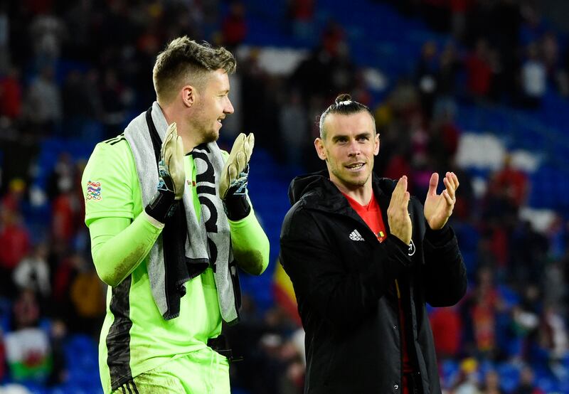 Gareth Bale and Wayne Hennessey applaud fans after the match. Reuters