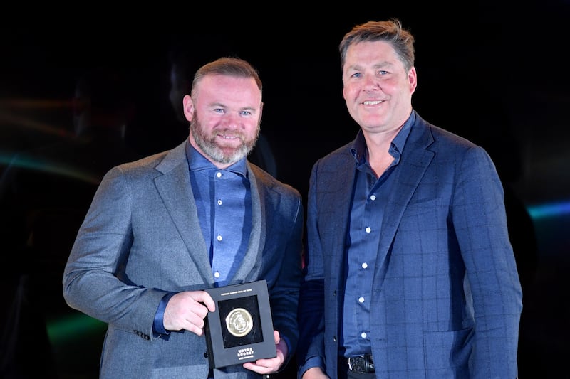 Wayne Rooney receives his Premier League Hall of Fame medallion from Premier League chief executive Richard Masters on April 21, 2022 in London. Getty