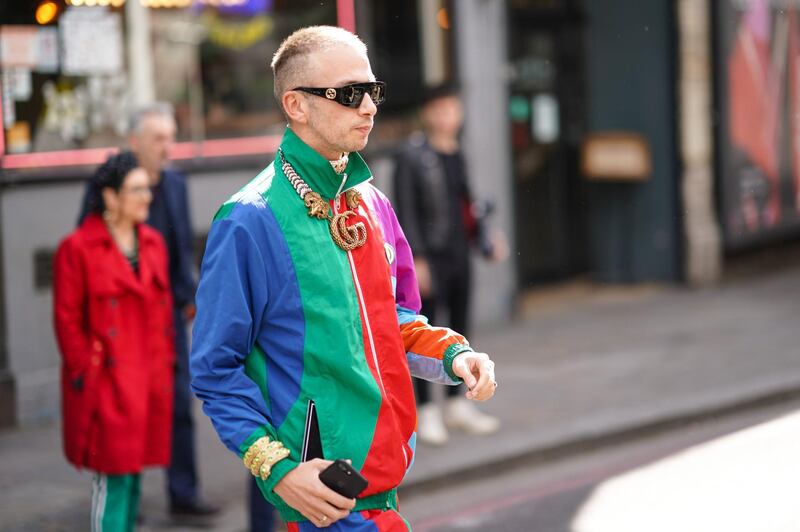 LONDON, ENGLAND - JUNE 08: A guest wears Gucci sunglasses, a blue red and green sportswear sweater, a Gucci necklace, during London Fashion Week Men's June 2019 on June 08, 2019 in London, England. (Photo by Edward Berthelot/Getty Images)
