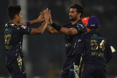 Quetta Gladiators's Sohail Khan (2R) celebrates with team mate Mohammad Hasnain (L) after the dismissal of Islamabad United's Amad Butt (unseen) during the Pakistan Super League (PSL) Twenty20 cricket match between Quetta Gladiators and Islamabad United at The National Cricket Stadium in Karachi on February 20, 2020. / AFP / Asif HASSAN