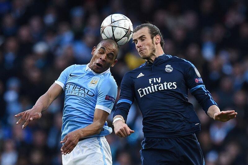 Real Madrid forward Gareth Bale and Manchester City midfielder Fernando go up for a high ball. Paul Ellis / AFP