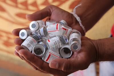 epa09110033 A medical worker shows vials of COVID-19 vaccine at a clinic in Misrod village, Bhopal, India, 01 April 2021. Phase three of the COVID-19 vaccination has started in India on 01 April for people aged 45 and above.  EPA/SANJEEV GUPTA