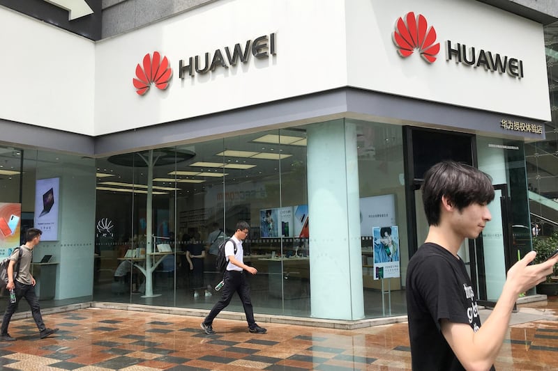 People walk past a Huawei store in Shenzhen, Guangdong province, China July 10, 2019. Picture taken July 10, 2019. REUTERS/Stringer  ATTENTION EDITORS - THIS IMAGE WAS PROVIDED BY A THIRD PARTY. CHINA OUT.
