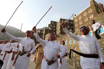 Saudi men perform a traditional folk dance at the cultural village of Rijal Almaa. Reuters