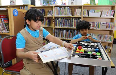 Saeed Rashed AlMheiri, right, and AlDhabi Rashed AlMheiri, left, playing a robotics game. Nilanjana Gupta/ The National