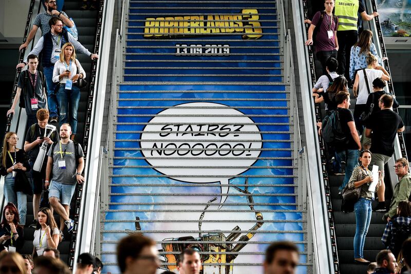 Visitors push forward on escalators at the Gamescom convention in Cologne, Germany.  EPA