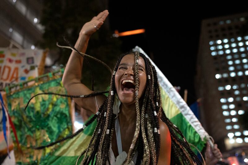 A reveller at a street party during a protest against restrictions by city officials in Rio de Janeiro, Brazil.  City Hall banned the street parties during carnival celebrations, which were delayed by almost two months because of the pandemic.  AP