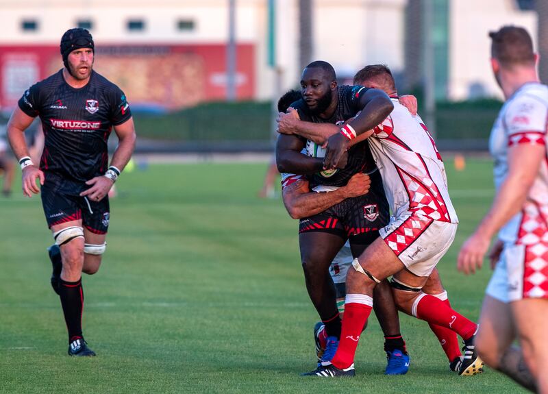 Brad Owaka is tackled during  Abu Dhabi Harlequins v Dubai Exiles at Zayed Sports City rugby fields.