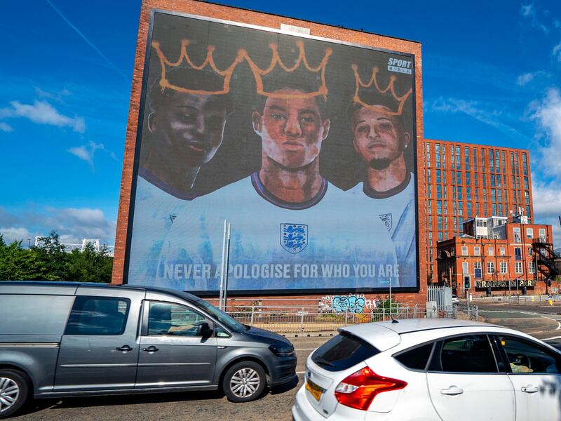 A digital mural of England players Marcus Rashford, Jadon Sancho and Bukayo Saka is displayed in Manchester.  AP Photo