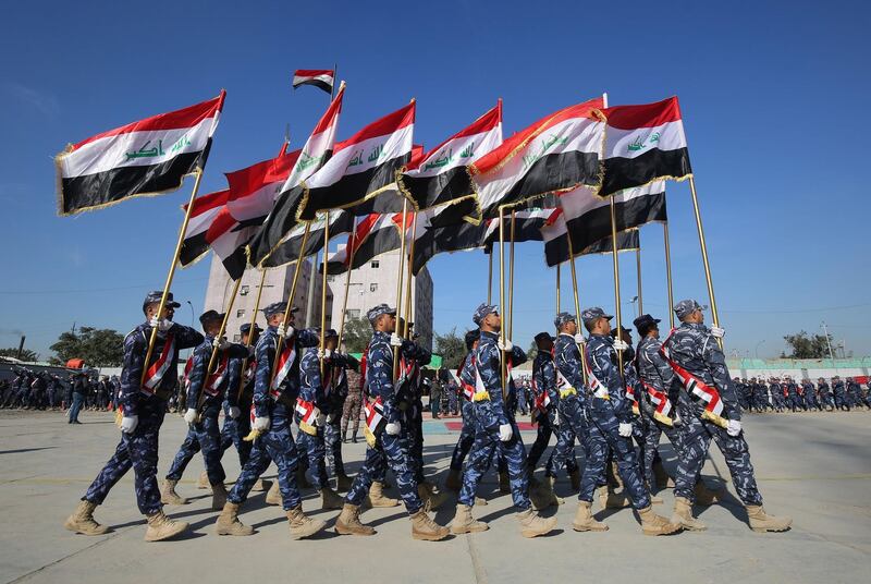 TOPSHOT - Iraqi policemen march during a parade in Baghdad on January 10, 2019 to mark the graduation of 158 Iraqi policemen after a six-month training period. / AFP / AHMAD AL-RUBAYE
