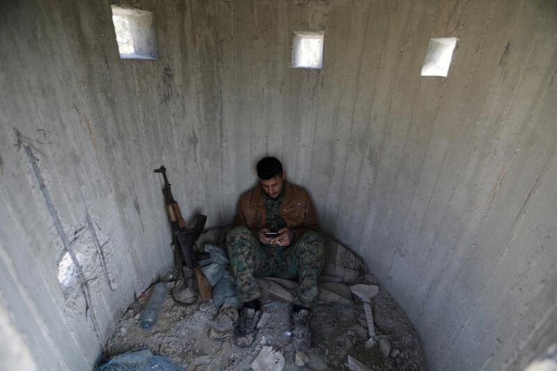 A Turkish-backed Free Syrian Army fighter rests at mount Bafliyun, in the Afrin region, Syria March 5, 2018. REUTERS/Khalil Ashawi