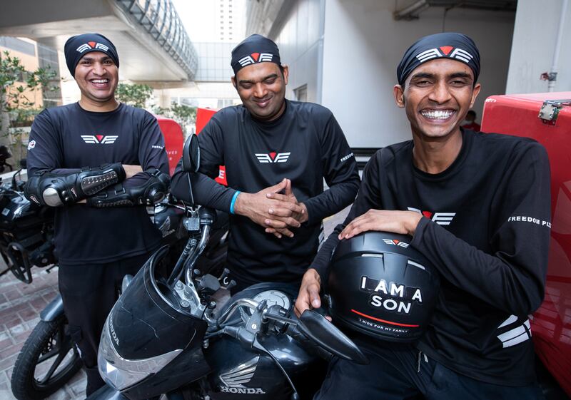 Delivery riders Usama Muhammad, Ashraful Kamal and Muhammad Faizan work at Freedom Pizza in Dubai. Victor Besa / The National