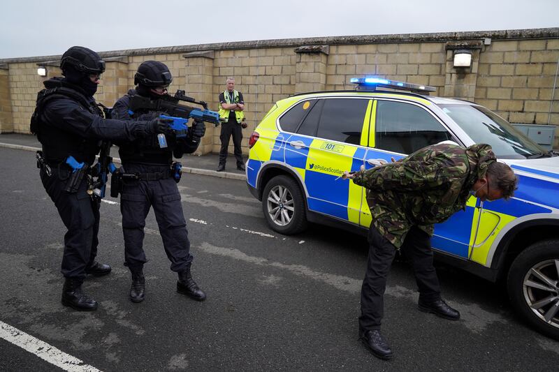 Police Scotland officers take part in a role-play exercise involving an armed policing response stopping a suspect in a vehicle during Cop26 public order training in East Kilbride. PA