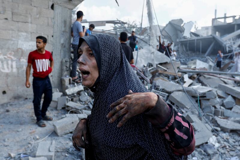 A Palestinian woman surveys the damage following Israeli strikes in Rafah. Reuters