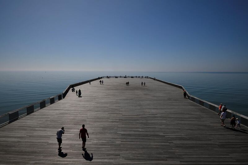 Visitors enjoy the weather as they walk on Hastings Pier at Hastings, United Kingdom. Toby Melville / Reuters