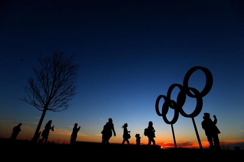 Cycling fans walk past the Olympic Rings at sunset inside the Olympic Park London, England. Dan Istitene / Getty 