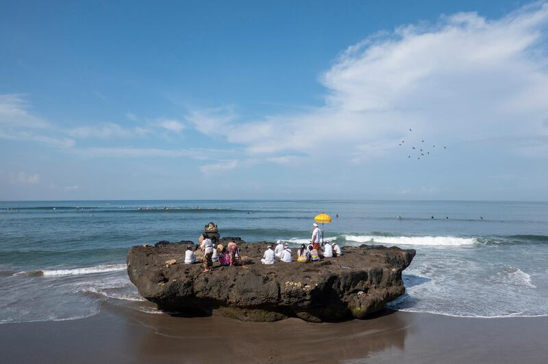 Hindu devotees pray during a cleansing ceremony called 'Melasti' at a beach in Canggu, Bali, Indonesia. EPA