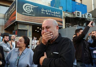 Colleagues of Farah Omar and Rabih Al Maamari mourn them outside the channel's office in Beirut. Reuters