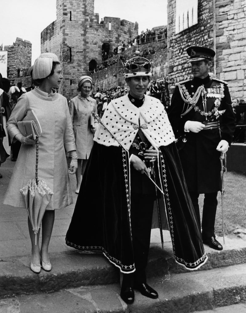 Prince Charles (centre) wearing a crown and robes after a ceremony where he was invested as the Prince of Wales, with Queen Elizabeth II (left) and the Duke of Edinburgh (right) at Caernarvon Castle, Wales, July 2nd 1969. (Photo by Dennis Oulds/Central Press/Getty Images)