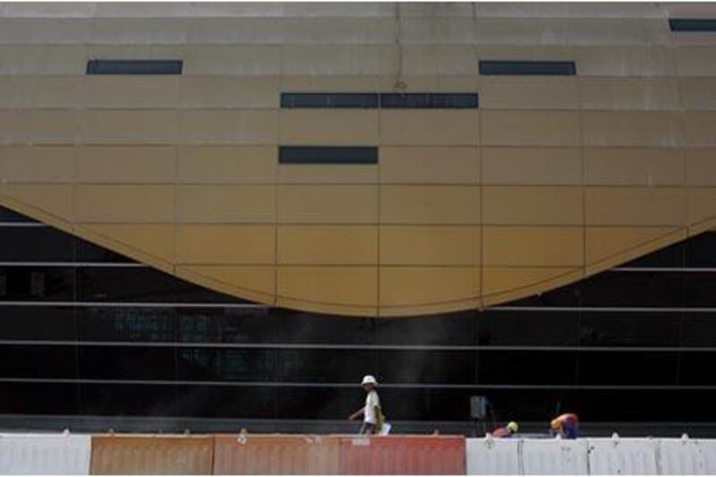 A construction worker walks past the Ibn Battuta Mall station in Dubai. Transport authorities have announced that only 10 stations will open when the Metro rolls out next week.