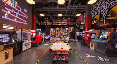 Arcade games and exposed ceiling pipes at The Central in Abu Dhabi. Courtesy Solutions Leisure Group