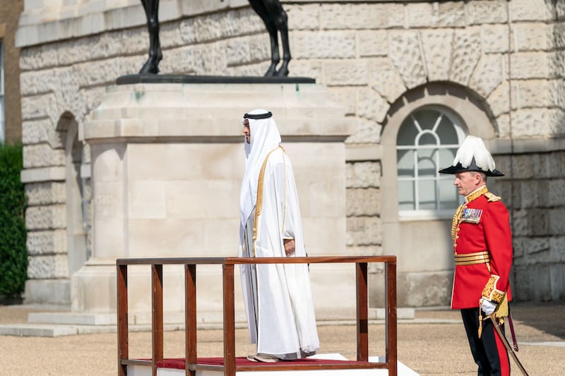 Sheikh Mohamed bin Zayed at a military guard of honour before attending a UK-UAE business reception. Ministry of Presidential Affairs