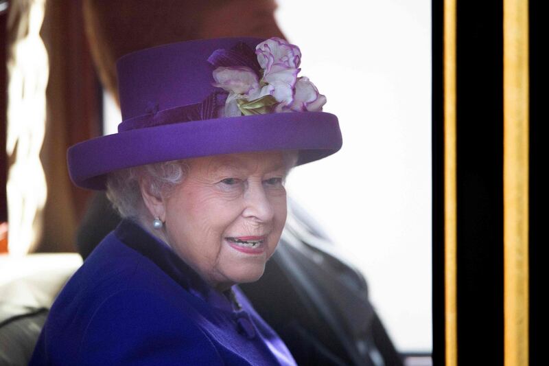 Britain's Queen Elizabeth II and King Willem-Alexander of the Netherlands (unseen) ride together in the State Coach Britannia from a Ceremonial Welcome on Horse Guards Parade to Buckingham Palace in London at the start of the Dutch King and Queen's two-day state visit. Victoria Jones / AFP