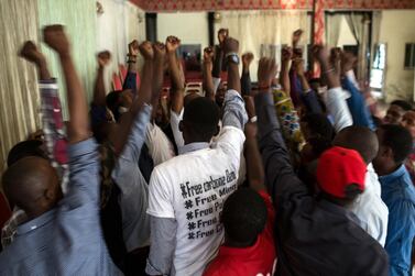 The Kinshasa cell of Filimbi, a pro-democracy group whose name means "whistle" in Swahili, end a secret meeting in Kinshasa with a cheer. Holly Pickett for The National