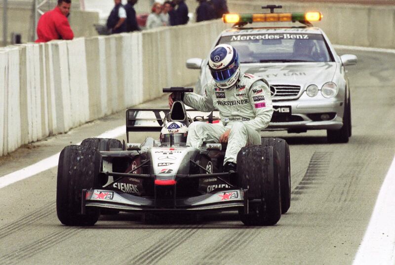 29 Apr 2001:  McLaren Mercedes driver Mika Hakkinen catches a lift from team mate David Coulthard after the Formula One Spanish Grand Prix at the Circuit de Catalunya in Barcelona, Spain. \ Mandatory Credit: Pascal Rondeau /Allsport / Getty Images