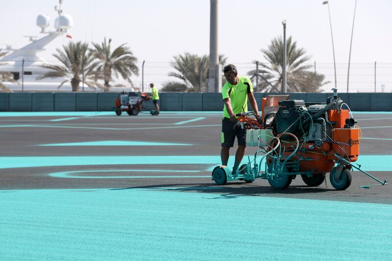 Preparations for the 2021 Abu Dhabi Grand Prix began long before the teams arrived. A painter uses a machine to paint the track in November ahead of the F1 season finale. Khushnum Bhandari /  The National