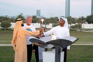 Sheikh Mohammed bin Rashid and Sheikh Mohamed bin Zayed light a cauldron with the Special Olympics flame. Ministry of Presidential Affairs