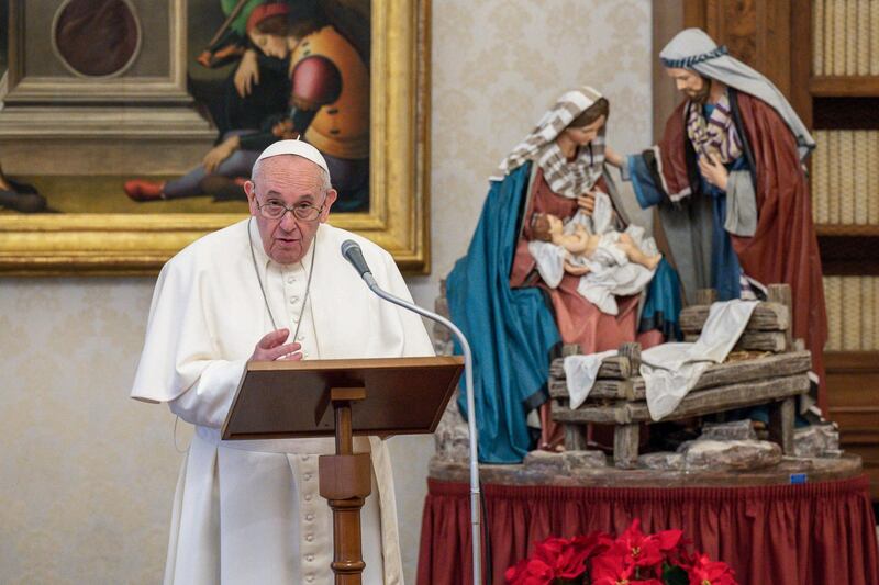 This photo taken on January 10, 2021 and handout on January 11, 2021 by the Vatican Media shows Pope Francis holding a weekly live streamed Angelus prayer by a Nativity Scene, from the library of the apostolic palace in The Vatican, during the COVID-19 pandemic caused by the novel coronavirus. RESTRICTED TO EDITORIAL USE - MANDATORY CREDIT "AFP PHOTO / VATICAN MEDIA" - NO MARKETING - NO ADVERTISING CAMPAIGNS - DISTRIBUTED AS A SERVICE TO CLIENTS
 / AFP / VATICAN MEDIA / Handout / RESTRICTED TO EDITORIAL USE - MANDATORY CREDIT "AFP PHOTO / VATICAN MEDIA" - NO MARKETING - NO ADVERTISING CAMPAIGNS - DISTRIBUTED AS A SERVICE TO CLIENTS
