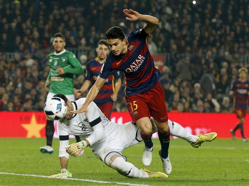 Marc Bartra of Barcelona fights for the ball against Villanovense keeper Jose Fuentes during their contest on Wednesday night in the Copa del Rey. Albert Gea / Reuters