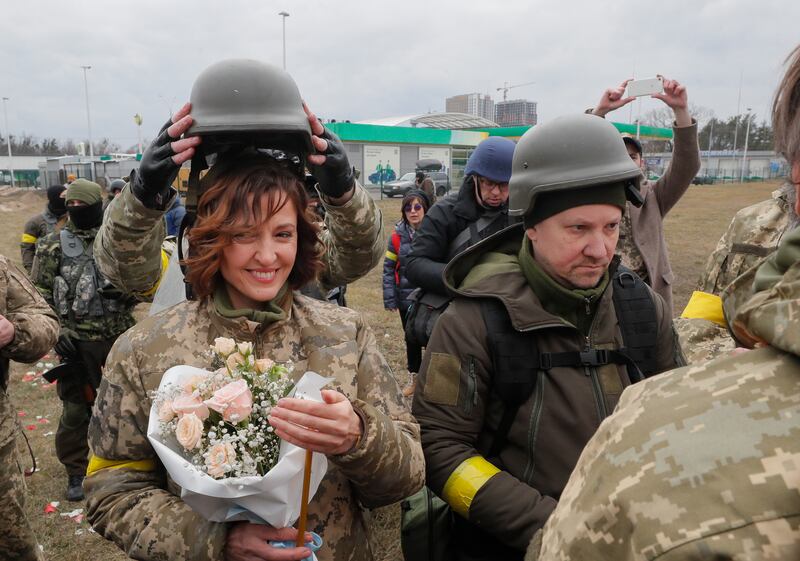 Ukrainian territorial defence fighters Valeriy, right, and Lesya during their wedding ceremony near Kyiv on March 6. EPA