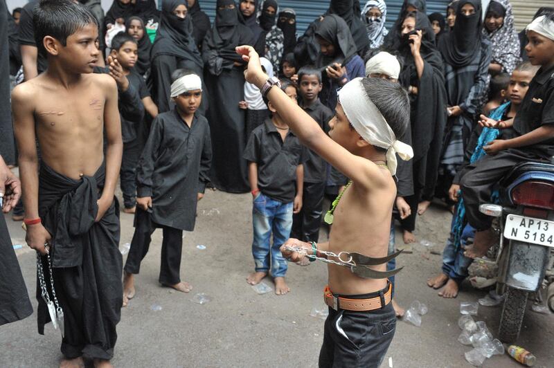 Indian Shiite Muslim children perform a ritual of self-flagellation during a religious procession during Ashura in Hyderabad. AFP