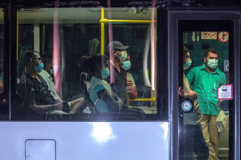 Abu Dhabi, United Arab Emirates, July 13, 2020.   
Bus commuters at downtown Abu Dhabi heading home during rush hour.
Victor Besa  / The National
Section:  Standalone
Reporter: