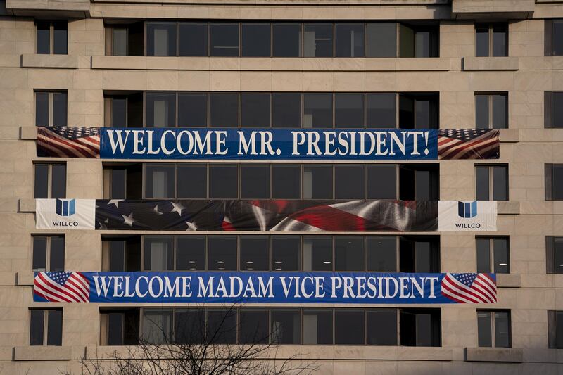 A sign welcoming the new President and Vice President is displayed on a building near Freedom Plaza in Washington, DC. AFP