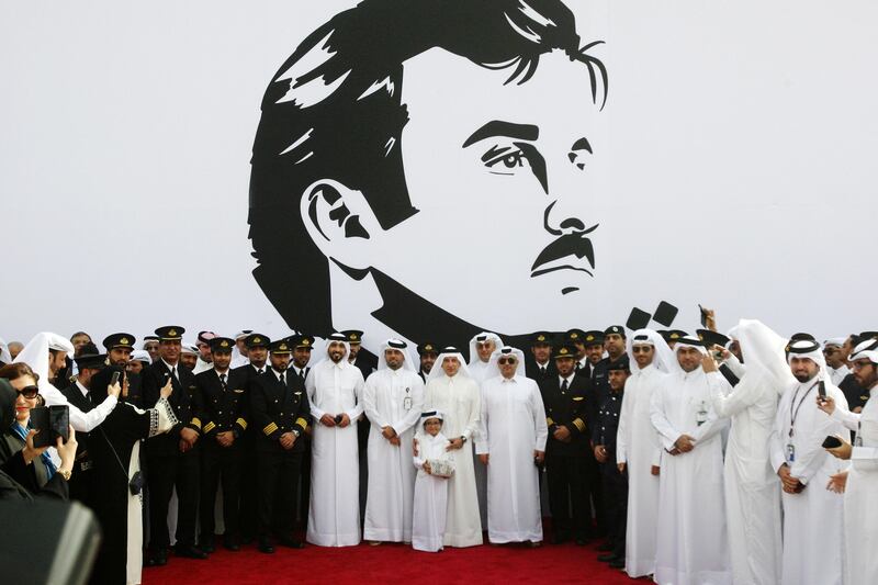 Qatar Airways Chief Executive Akbar al-Baker poses for a photo in front of an artwork depicting Qatar’s Emir Sheikh Tamim Bin Hamad Al-Thani in Doha, Qatar, July 13, 2017. REUTERS/Naseem Zeitoon