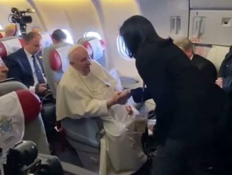 Pope Francis meets The National's Ramola Talwar Badam on the papal flight to Manama. He blessed a clutch of rosary beads for Catholic friends of Ramola's. Amy McConaghy / The National