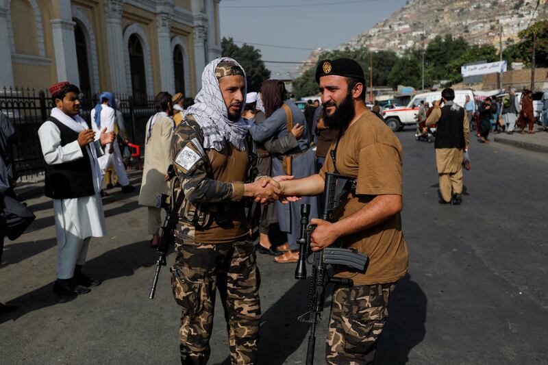 Taliban fighters greet each other outside the Shah-e Doh Shamshira Mosque in Kabul as the Eid Al Adha holiday begins. Reuters 