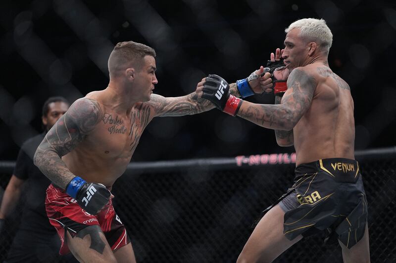 Dustin Poirier moves in with a hit against Charles Oliveira. Reuters
