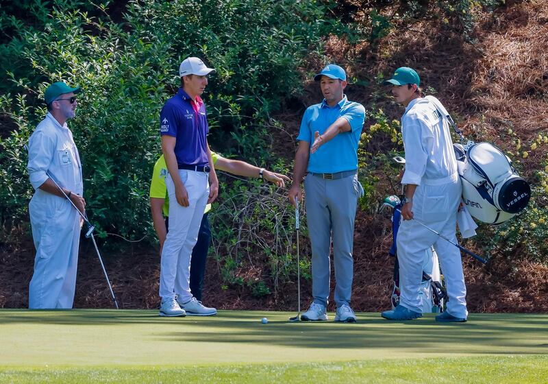 Sergio Garcia and Carlos Ortiz on the 12th green during a practice round for the 2021 Masters. EPA