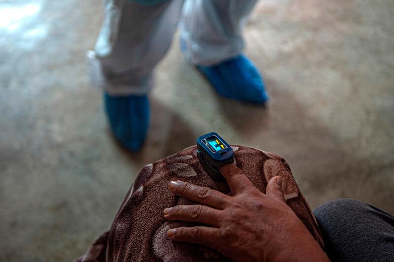 Doctors check the temperature of a Covid19 patient, in Comas, northern outskirts of Lima, Peru. AFP