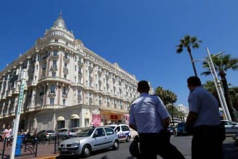 French policemen keep watch outside the Carlton Hotel in Cannes after an armed man held up the jewellery exhibition "Extraordinary diamonds" of the Leviev diamond house in one of the biggest jewel thefts ever.