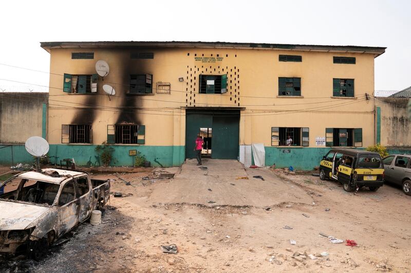 A man is seen standing in front of the main gate of the Nigerian Correctional Services facility that was attacked by gunmen, with large numbers of inmates set freed afterwards in Imo State, Nigeria. Reuters