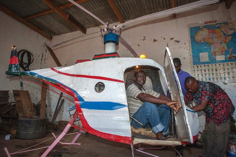 Malawian Felix Kambwiri sits in the cockpit of the helicopter he built out of scrap metal and fibreglass in his garage on February 19, 2016. Amos Gumulira/AFP

